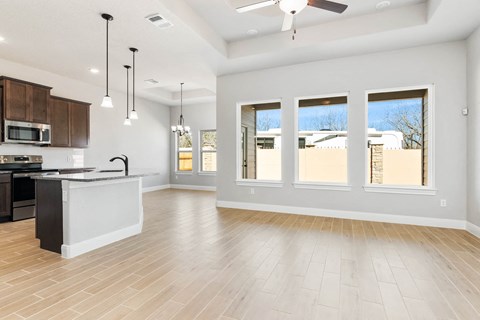 an open kitchen and living room with a large window