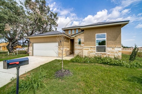 a house with a garage and a mailbox in front of it