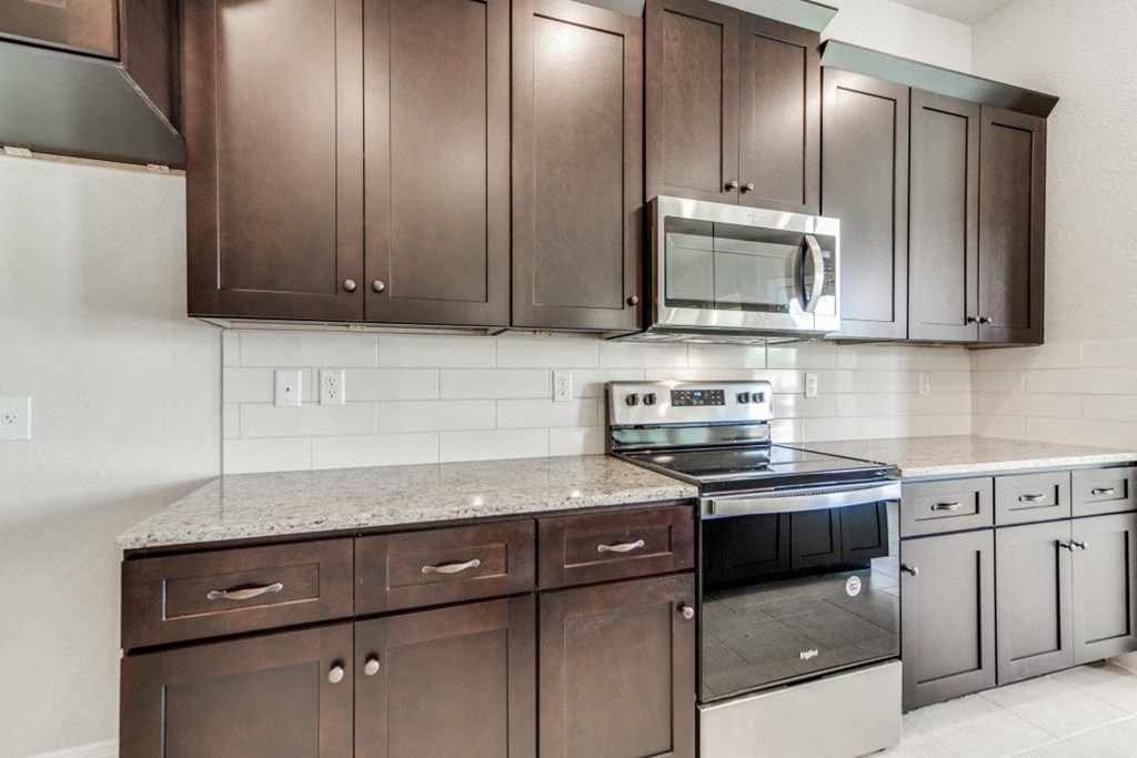 a kitchen with stainless steel appliances and wooden cabinets