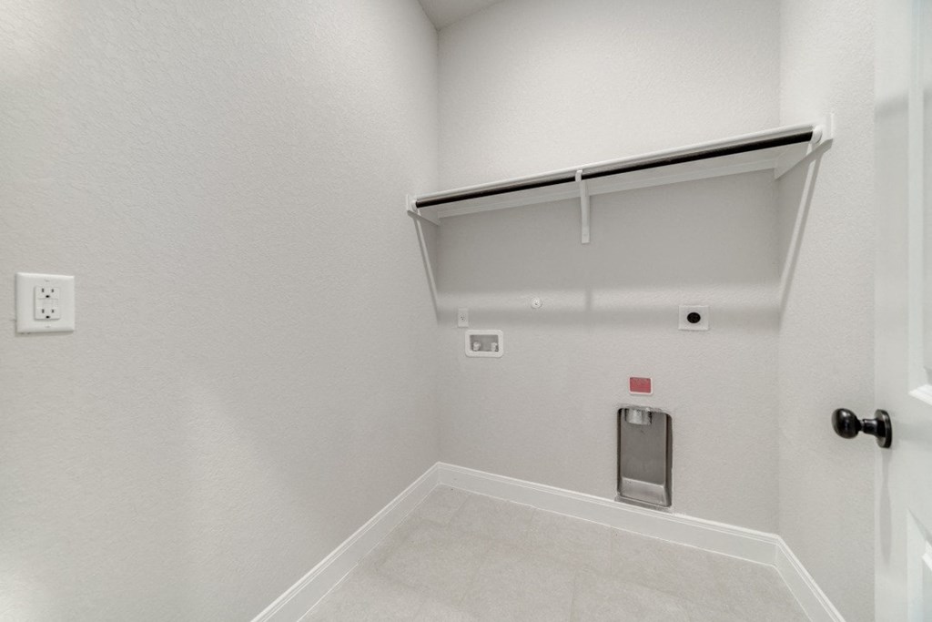 the living room has a white wall and a white door to the garage