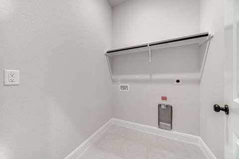 the living room has a white wall and a white door to the garage