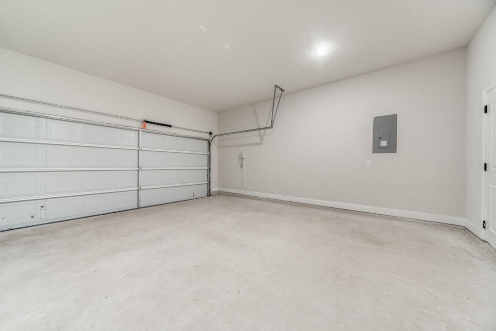 an empty garage with a white wall and a white garage door