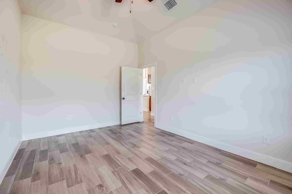 a living room with white walls and wood floors