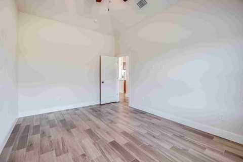 a living room with white walls and wood floors
