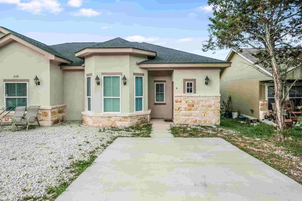 a house with a concrete walkway in front of it