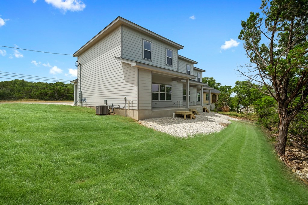 a home with a lawn and a picnic table in front of it