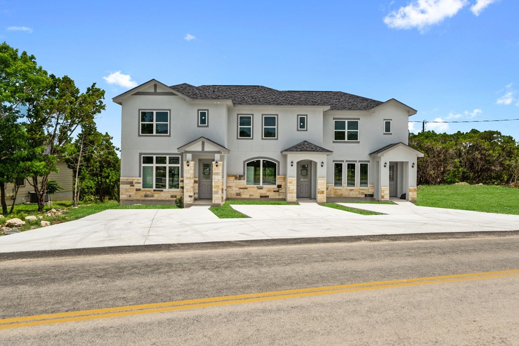 a large white house with a street in front of it