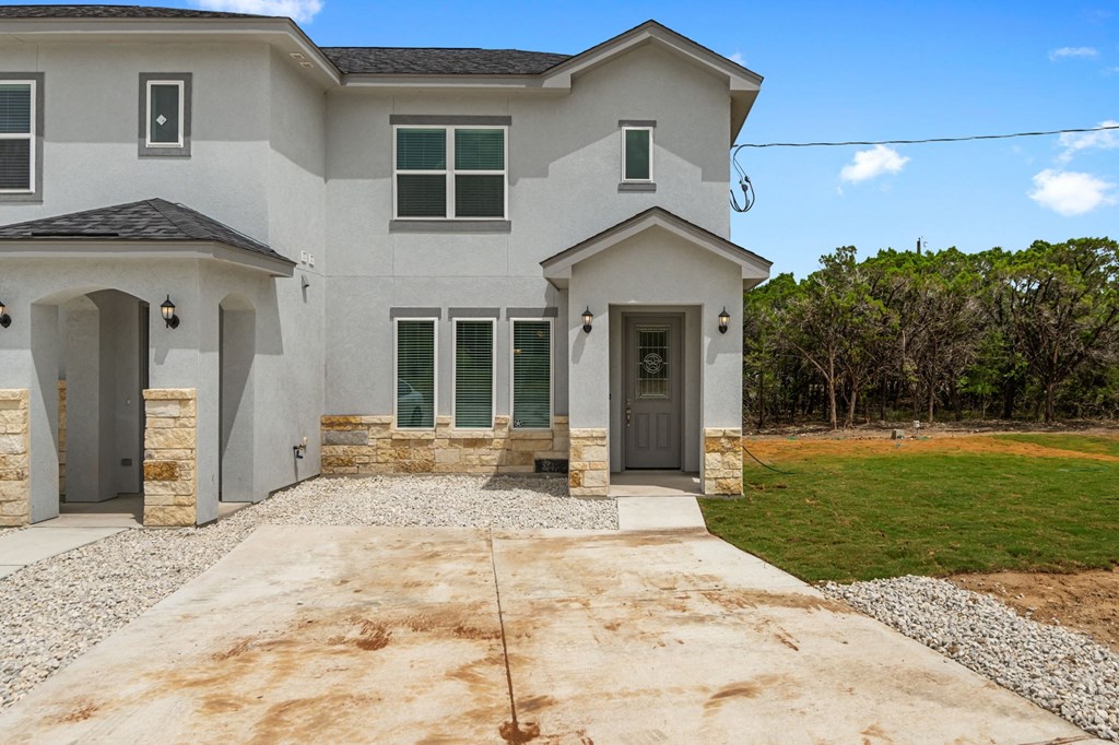 a new house with a driveway and a lawn