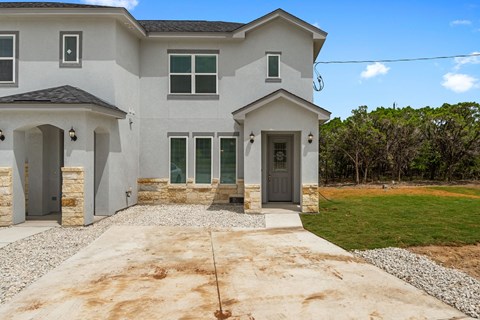 a new house with a driveway and a lawn