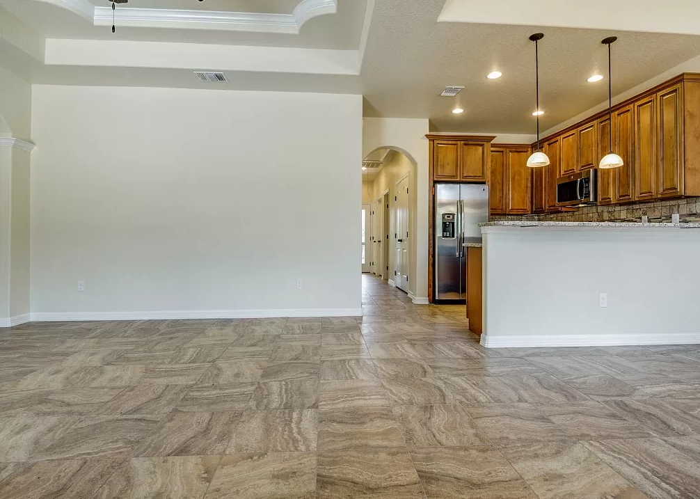 a kitchen and a living room with wood flooring