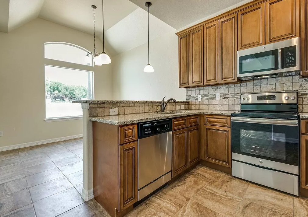 a kitchen with wooden cabinets and a counter top