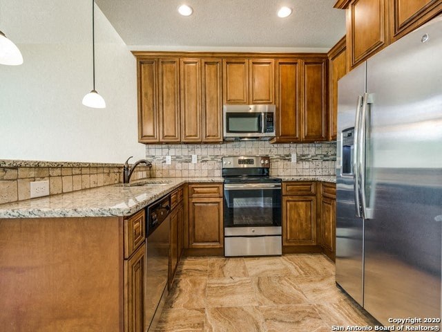 a kitchen with wooden cabinets and stainless steel appliances