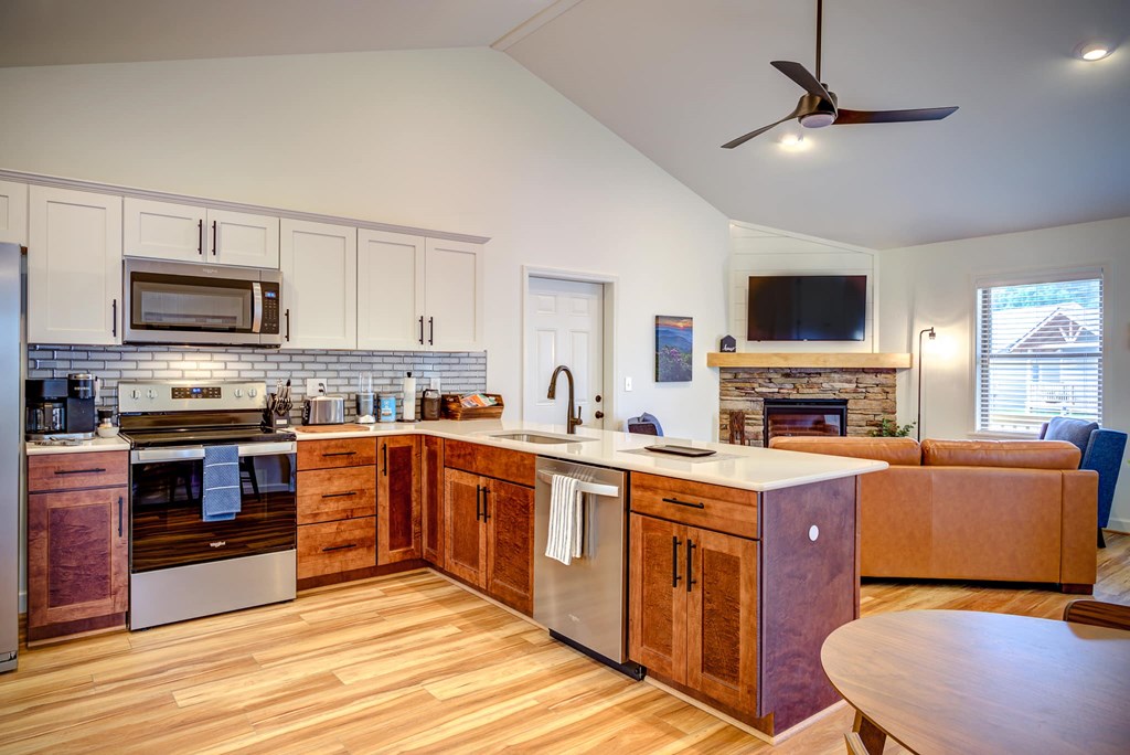 A kitchen with wooden cabinets and a tile backsplash.