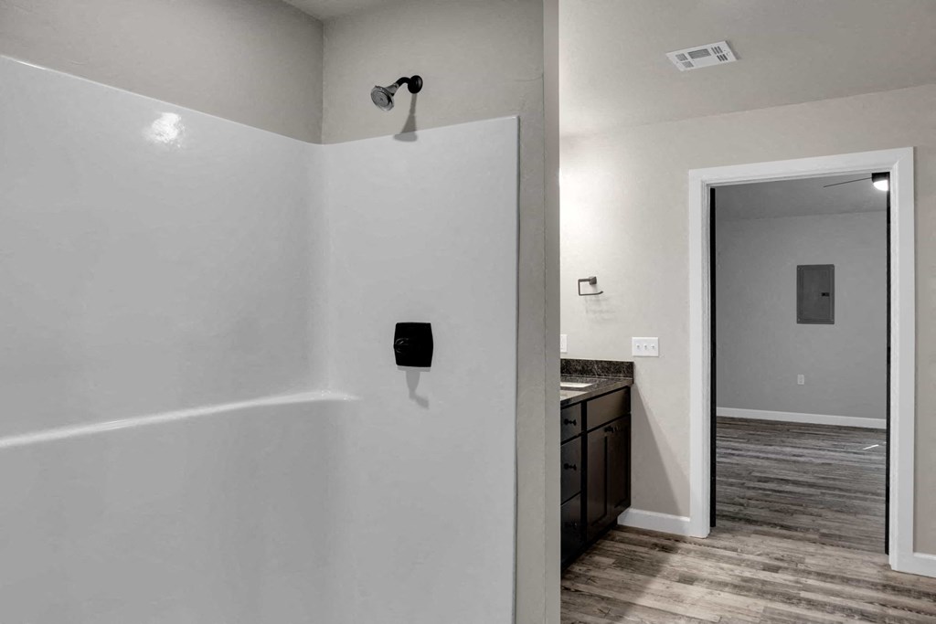 a bathroom with a white wall and a mirror and a sink