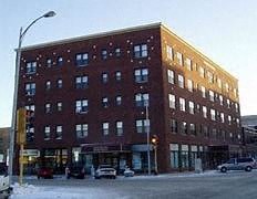 a large brick building on the corner of a street