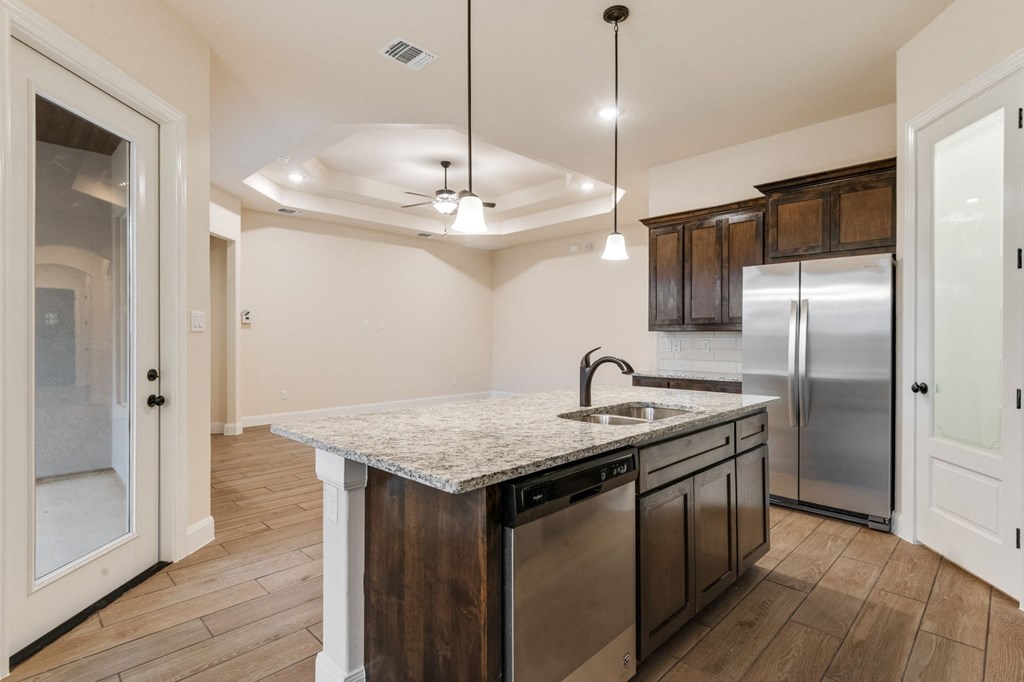 a kitchen with stainless steel appliances and a granite counter top