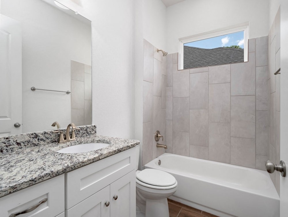 a bathroom with a sink toilet and a bath tub