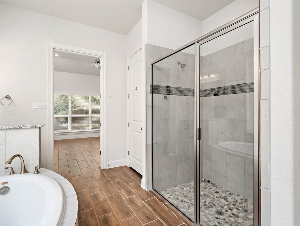 a white bathroom with a shower and a sink