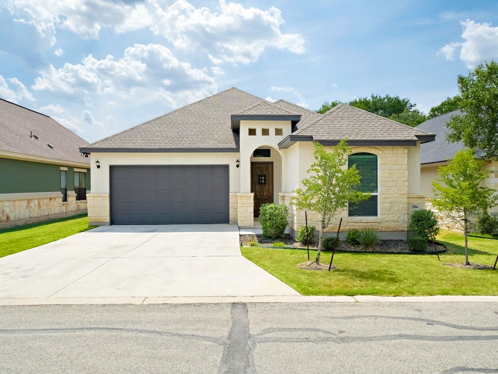 a house with a driveway and a garage door