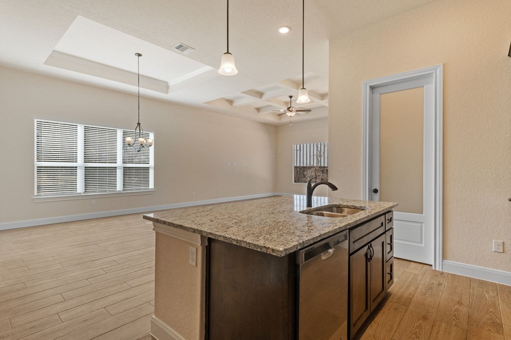 an empty kitchen with a counter top and a sink