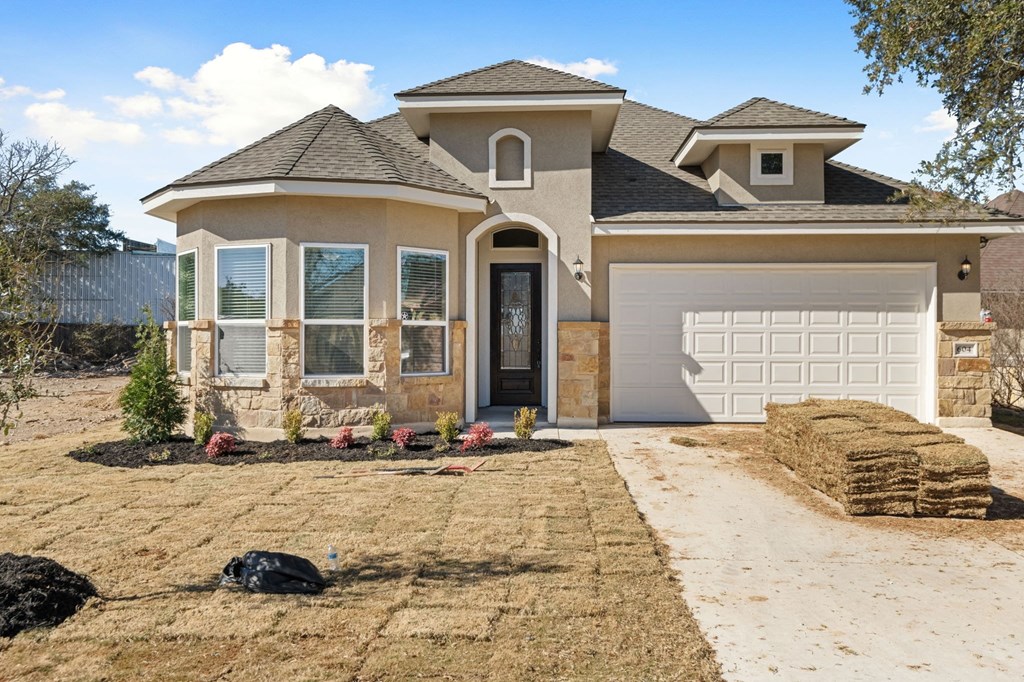 a house with a driveway and a garage door