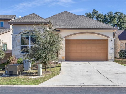 a house with a garage door and a driveway