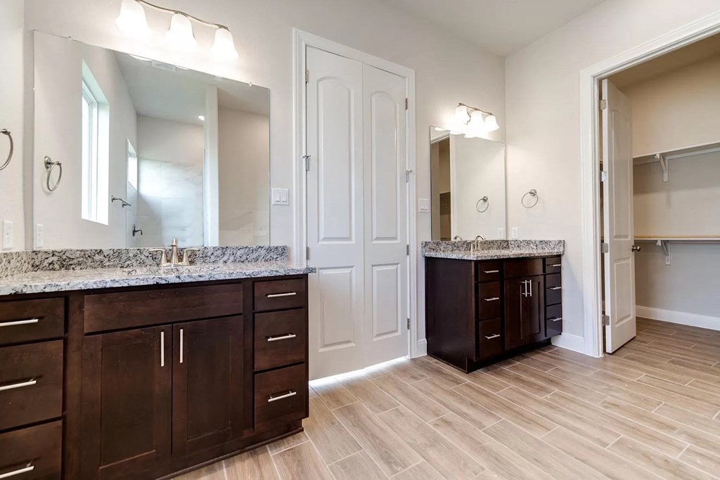 a bathroom with two sinks and a large mirror