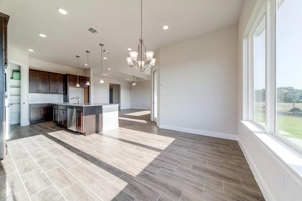 an open kitchen and living room with a large window