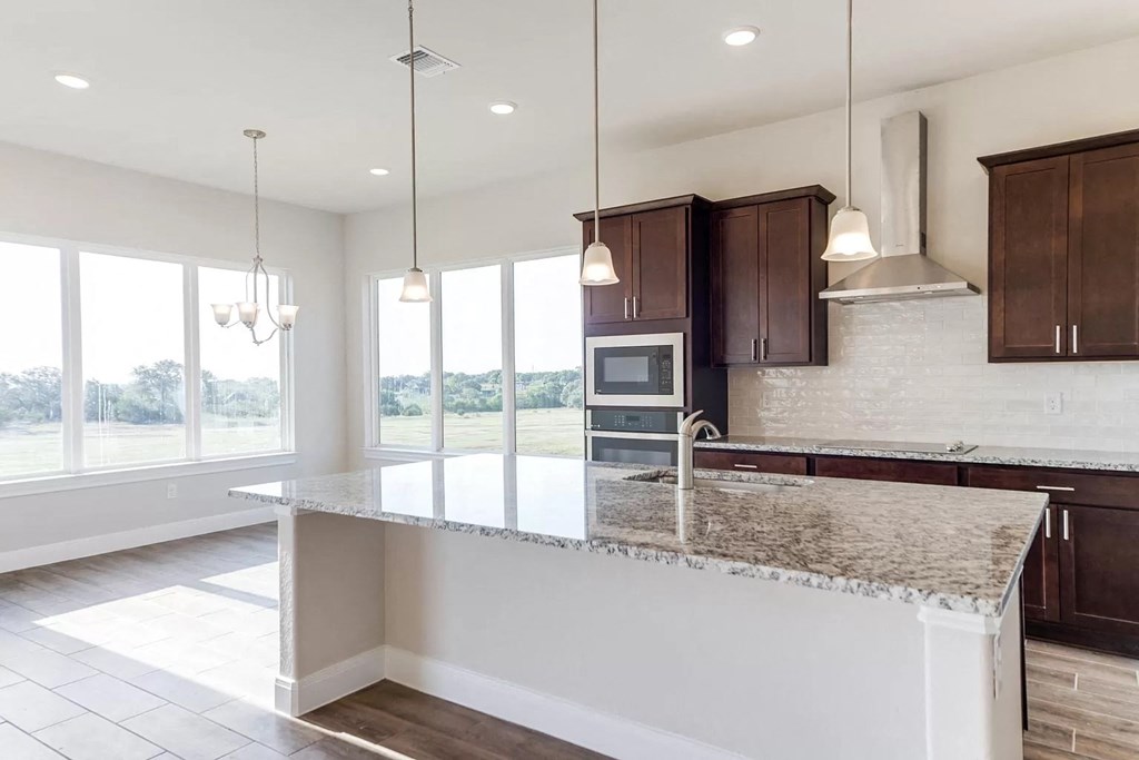 a kitchen with an island and a large window