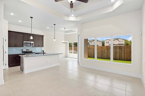 the kitchen is open to the living room and dining room