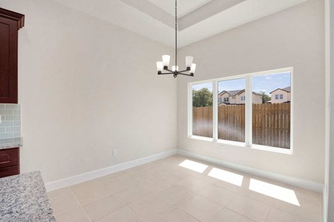 a living room with a window and a chandelier