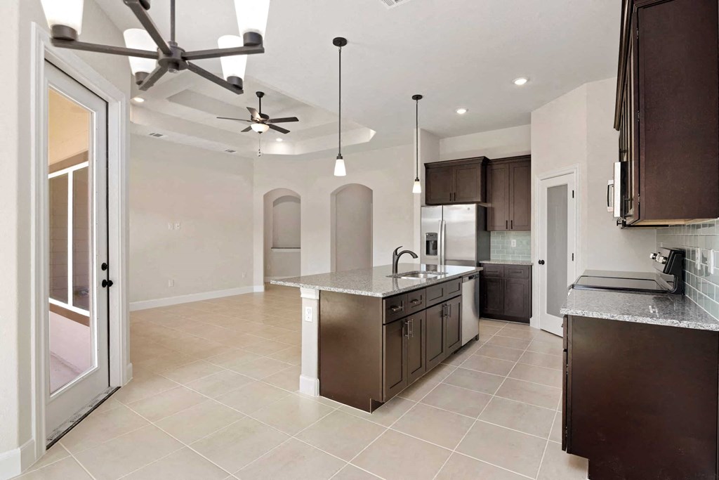 a kitchen with a sink and a refrigerator