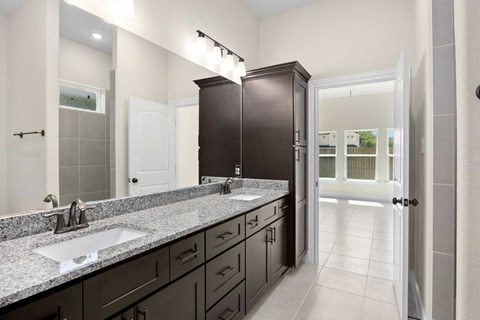 a bathroom with granite counter tops and a sink