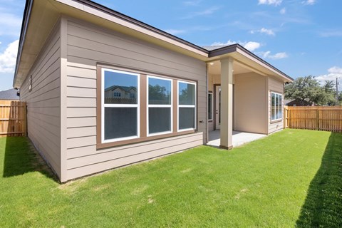 the exterior of a house with a lawn and a porch