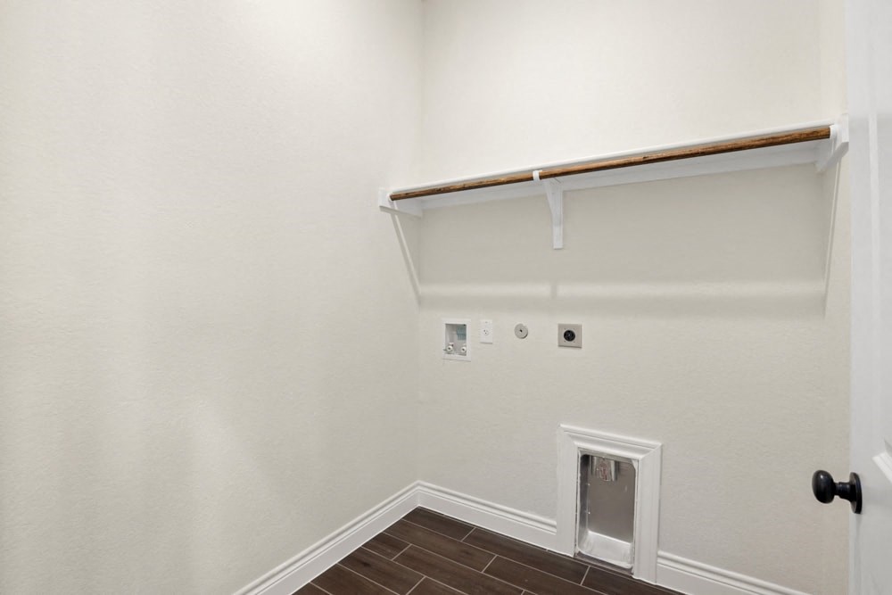 the living room of a home with a white wall and a door to the closet