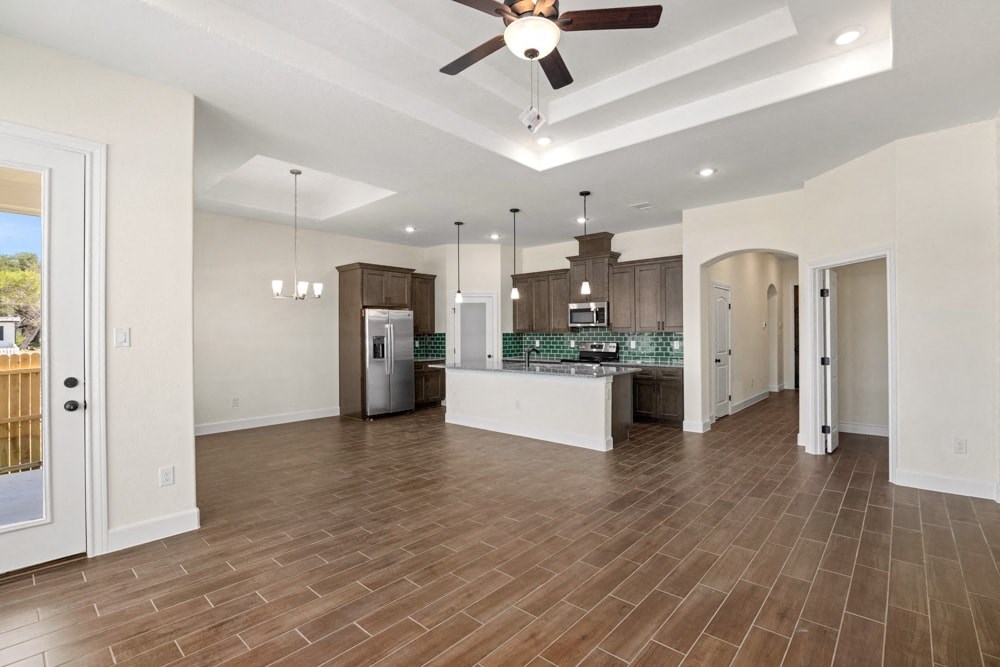 an open kitchen and living room with a ceiling fan
