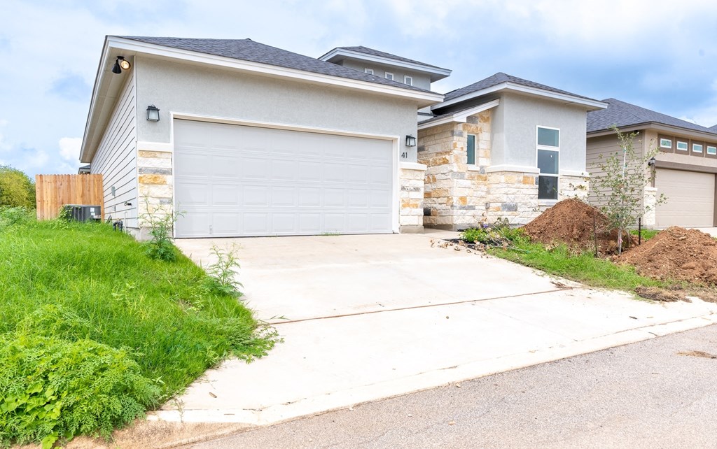 a house with a white driveway in front of it