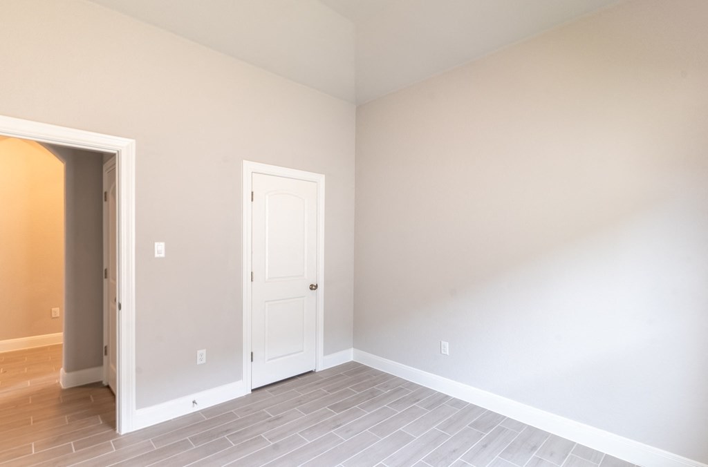 a empty room with a white door and a tile floor