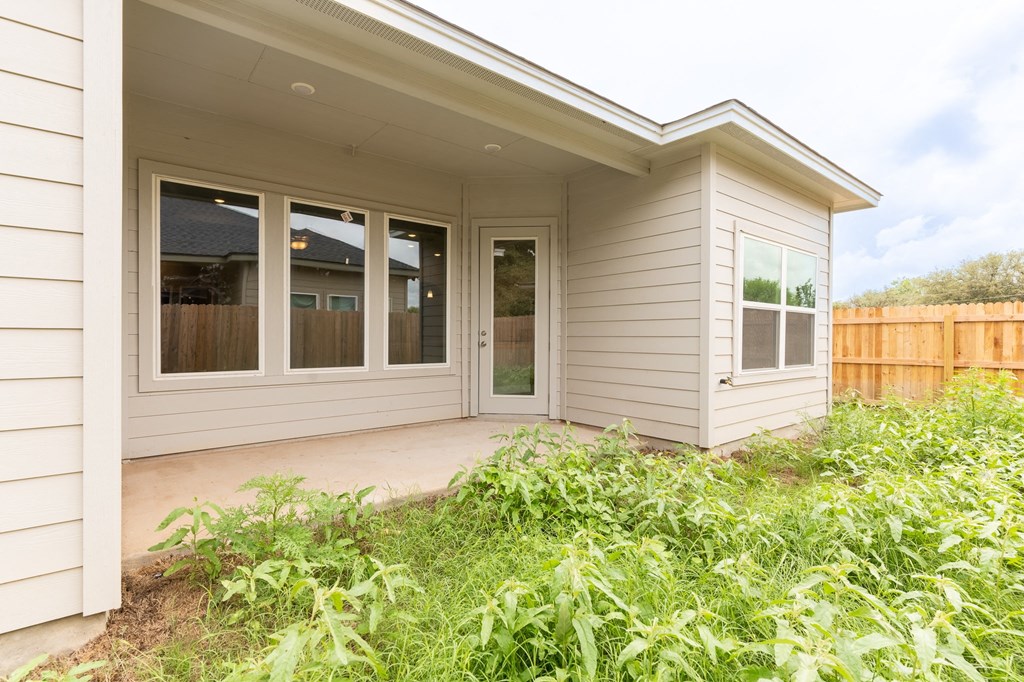 a covered porch in front of a white house