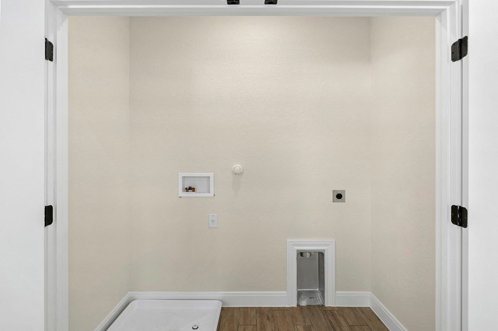 a bathroom with a white tub and a wall with a door