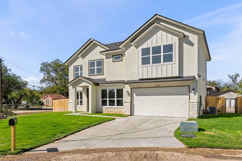 a house with a white garage door and a driveway