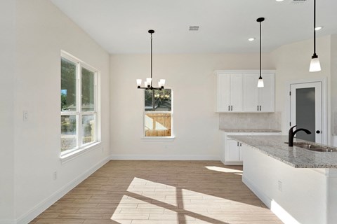 an open kitchen and living room with a large window