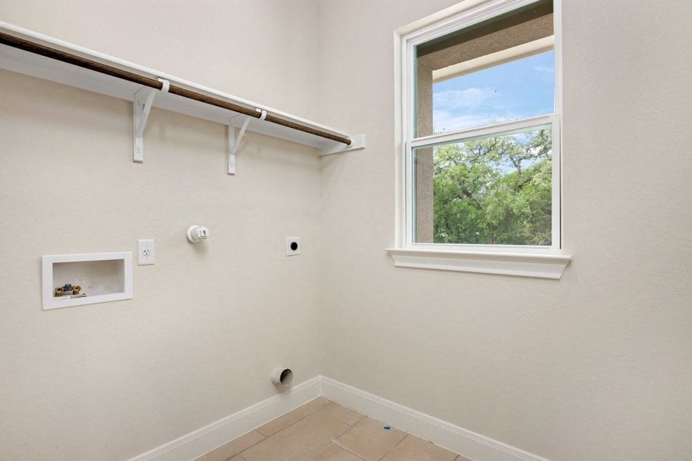 a room with a window and a white wall and a wall bracket on the wall