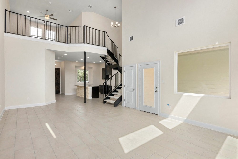 the spacious living room and entryway of a new home