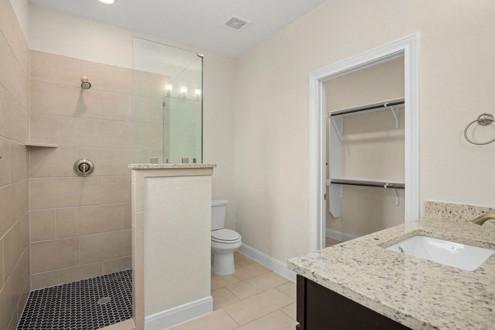 a bathroom with a shower and a sink and a toilet