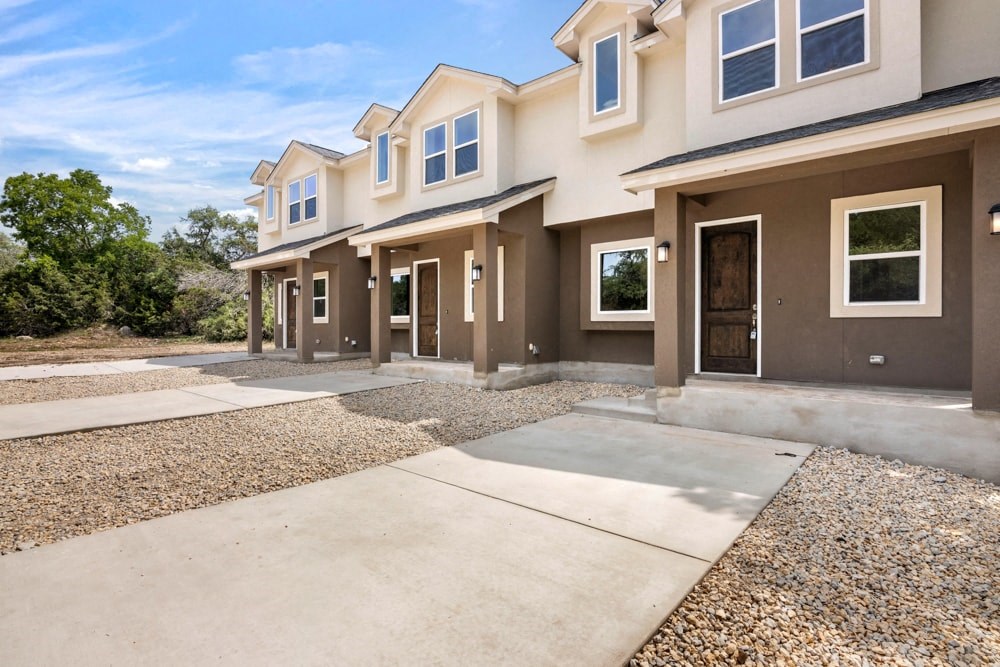 an empty driveway in front of a house