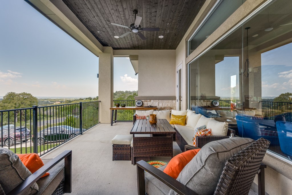 a covered patio with couches and a table