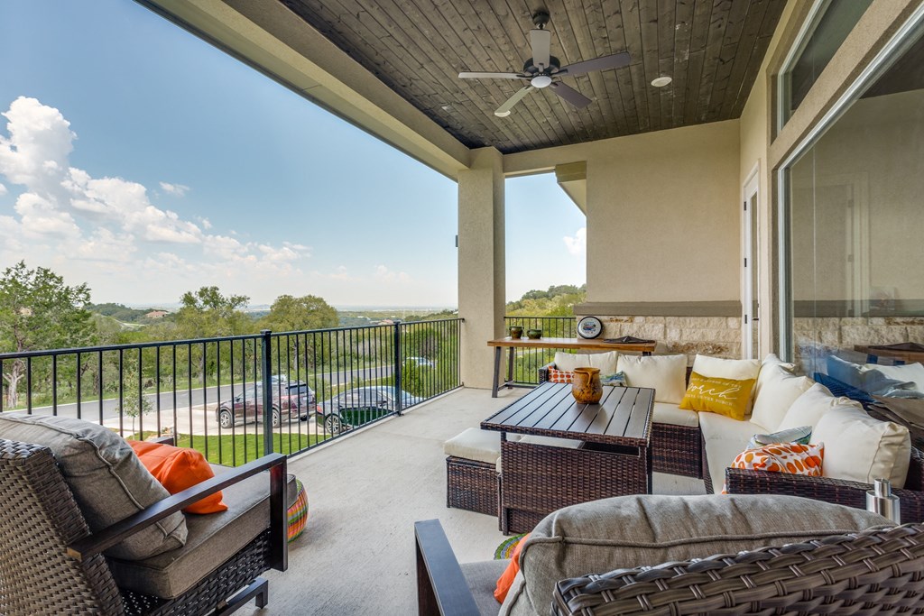 a covered patio with couches and a table