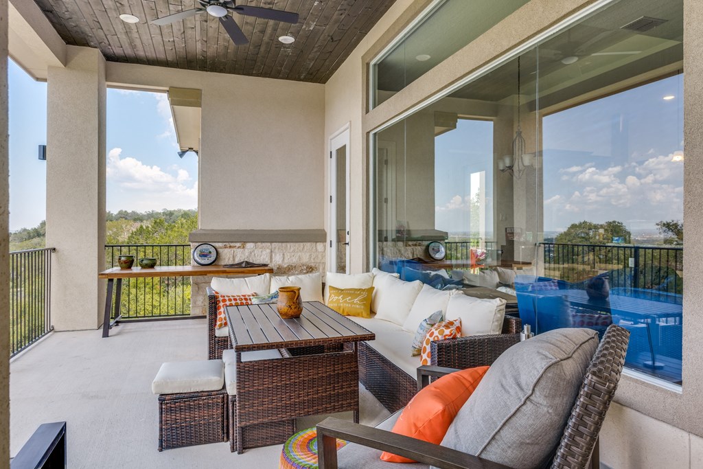 a covered patio with furniture and a table