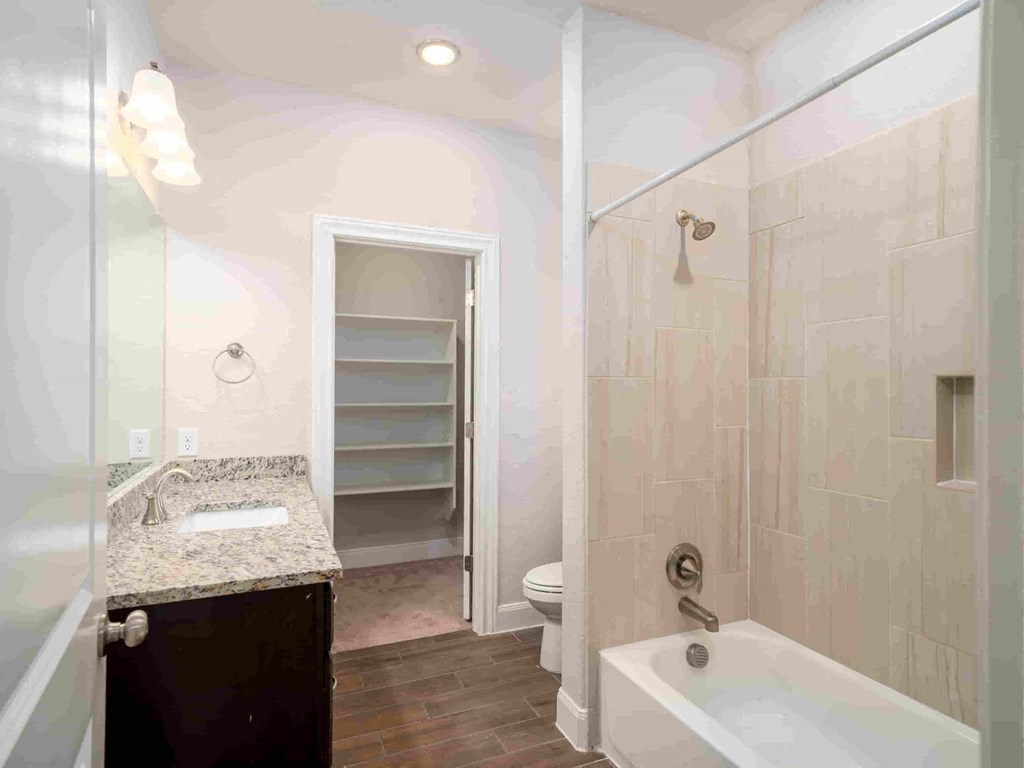 a bathroom with a shower and a sink and a toilet